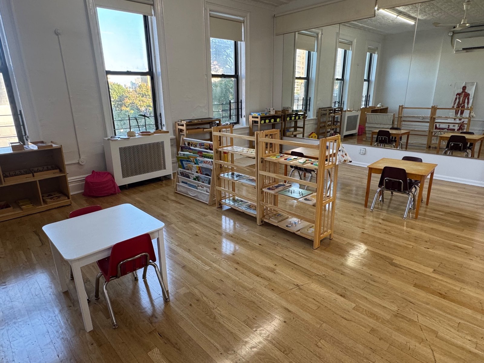 The classroom at Brooklyn Arts Exchange: tall windows, wood floors and child-sized tables